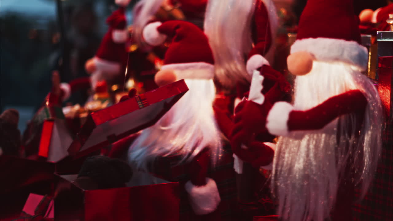 Multiple Santa Claus Christmas decorations moving in bubbles in the courtyard of the Monte Carlo Casino