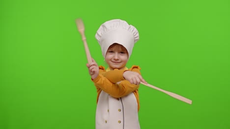 niña divertida niña niño vestido cocinero cocinero panadero en delantal y sombrero bailando, tonto, haciendo caras