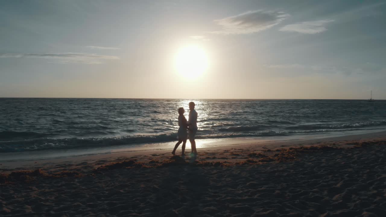 Romantic Sunset on a Tropical Beach with a Couple