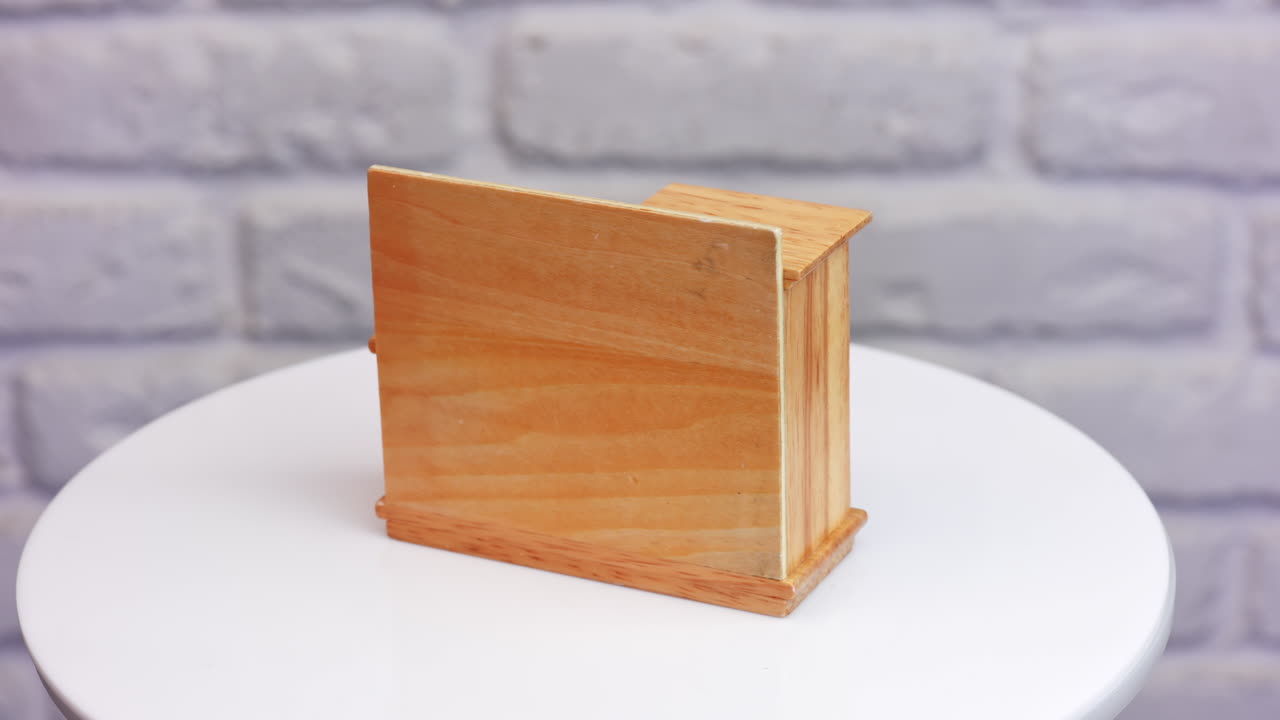 Cute piece of toy furniture on the rotating table. Little sink and shelves for doll's bathroom. Close up.