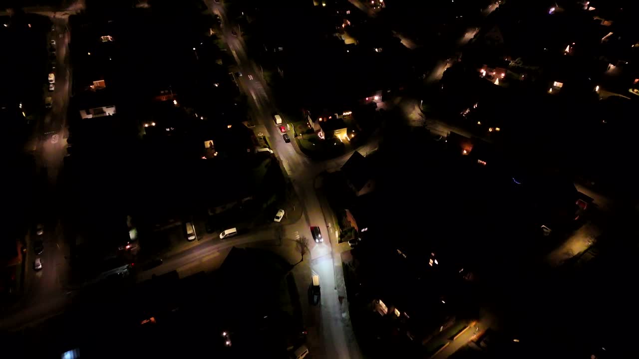 Apartment town houses at night. Twilight aerial view of a quiet suburban street with two-story houses in America. Driving car on street. Aerial top down shot