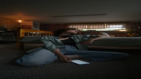 woman sitting on the floor in a bedroom