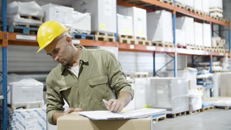 focused male worker in helmet signing documents