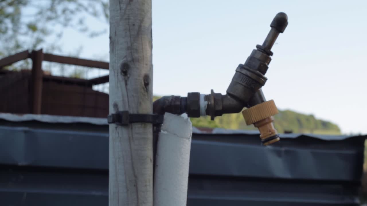 Faucet tap in garden medium panning shot