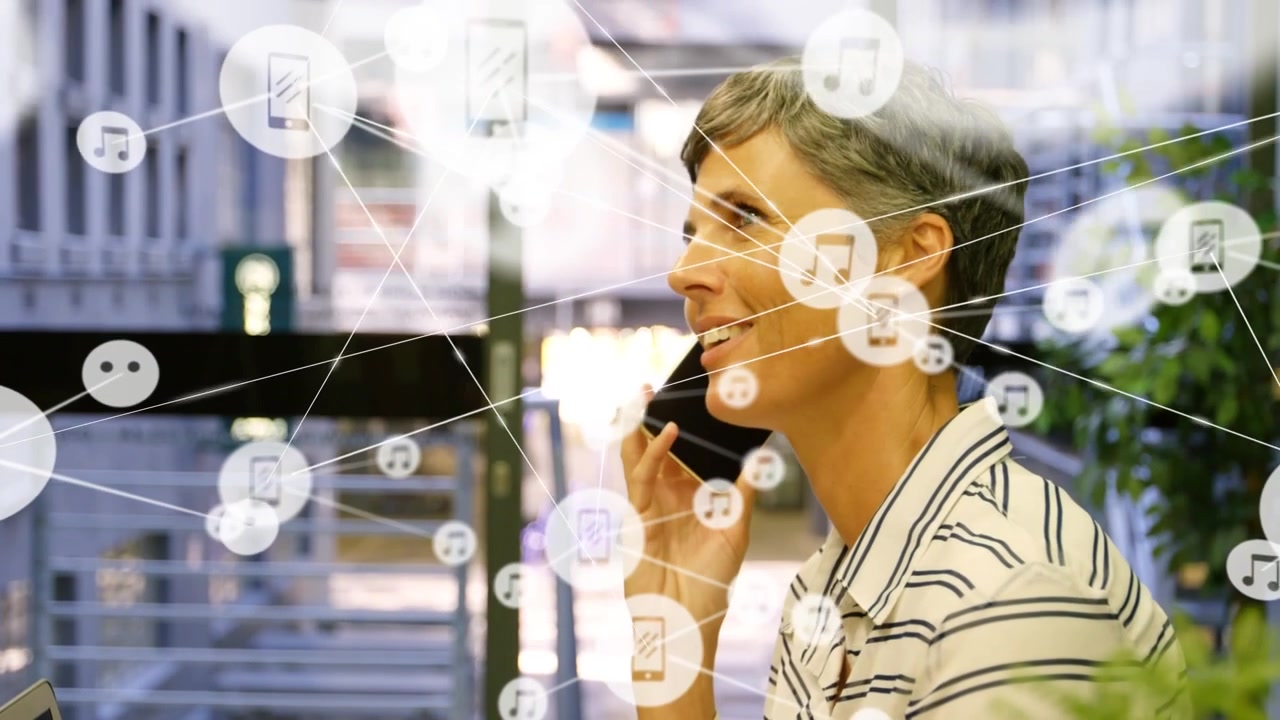 Network of digital icons against caucasian senior woman talking on smartphone at office