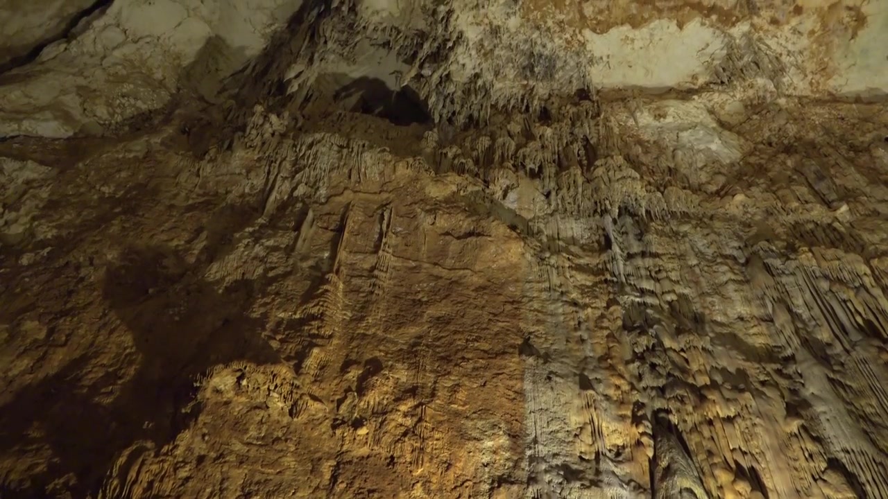 Stalactites and Rock Formations Inside a Deep Limestone Cave