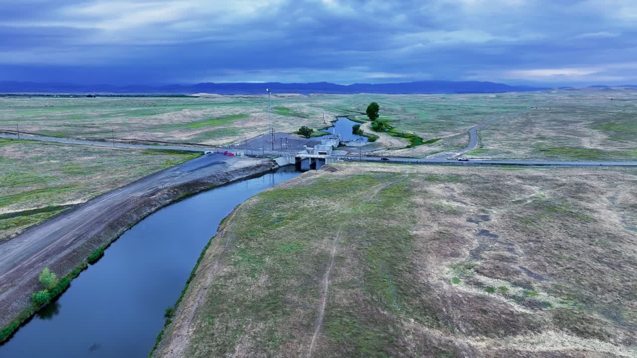 Aerial view of a canal with a storm brewing in the background