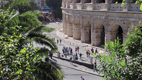 tourists walking near the colosseum in rome, italy