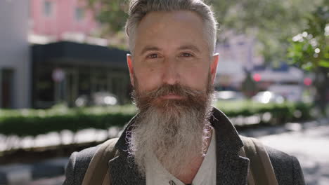 portrait-of-mature-sophisticated-bearded-man-staring-contemplative-looking-at-camera