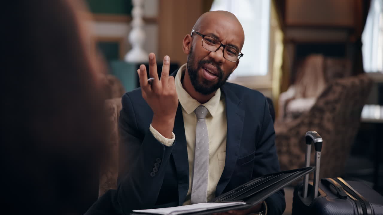 Businessman reviewing documents in hotel lobby
