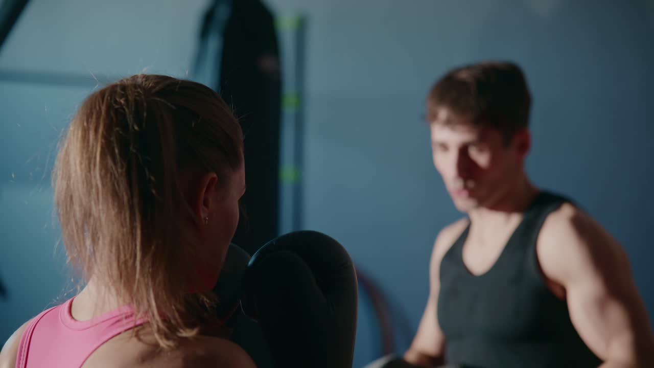 Woman Training Boxing with Personal Trainer in Gym