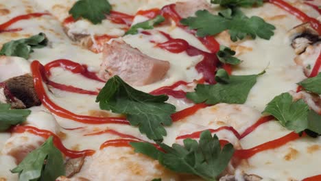 close-up of a pizza with mushrooms, ham, and parsley