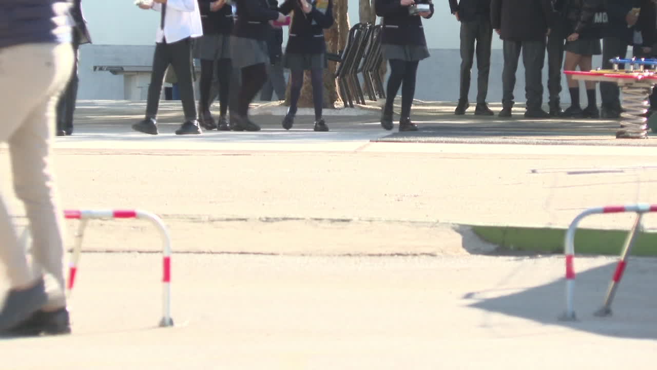 Students Walking in School Grounds