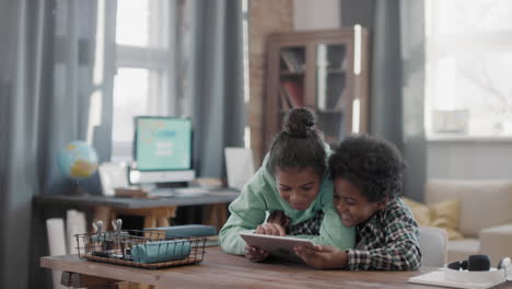 afro kids playing games on tablet
