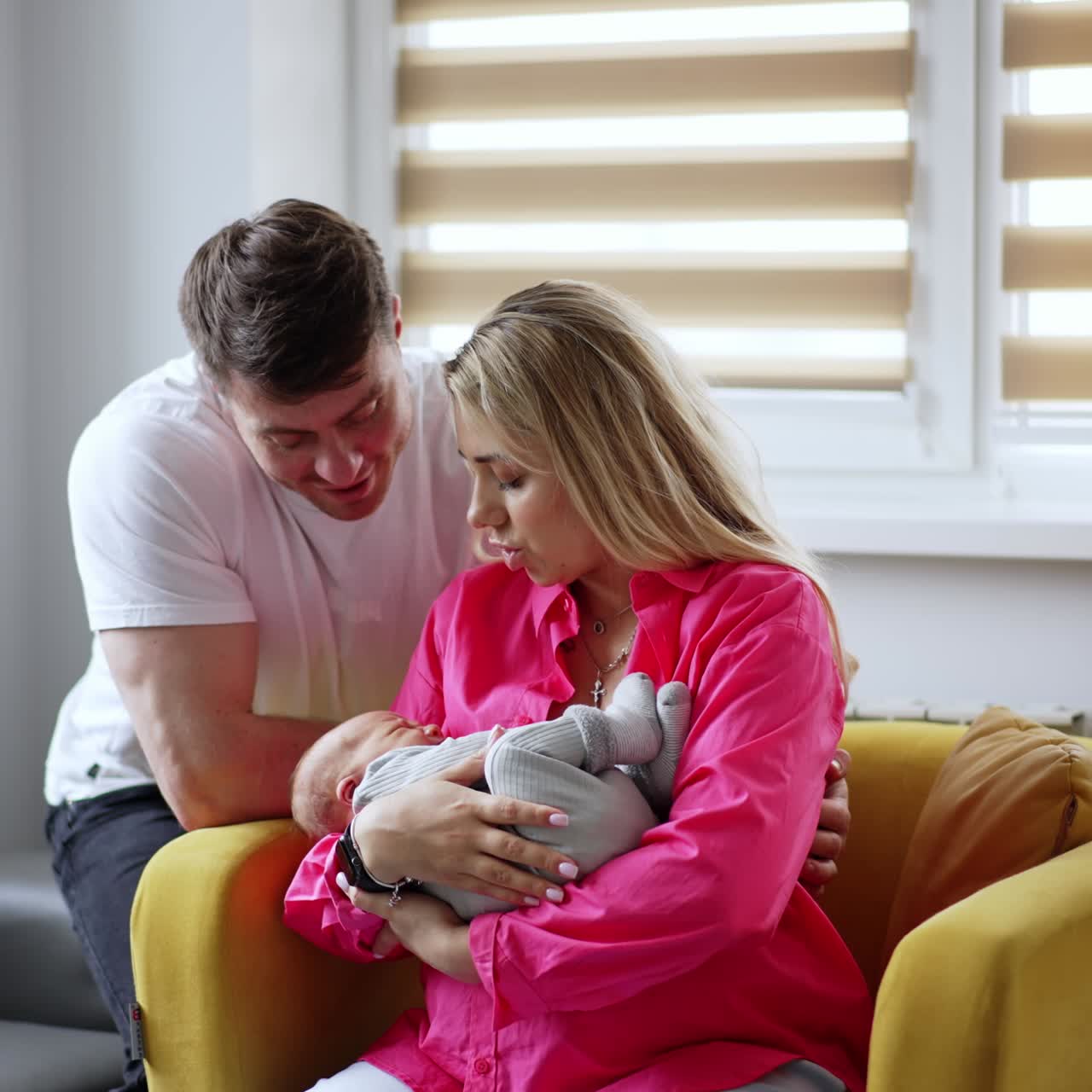 Loving new-made parents with their child. Couple swaying their baby in maternity hospital ward
