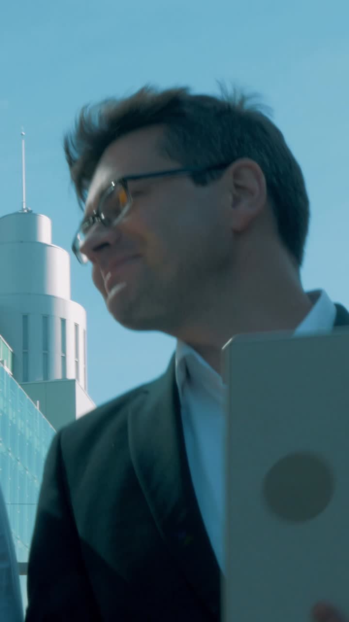 Business professional with laptop outdoors