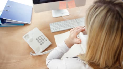 businessman talking on phone and working on computer