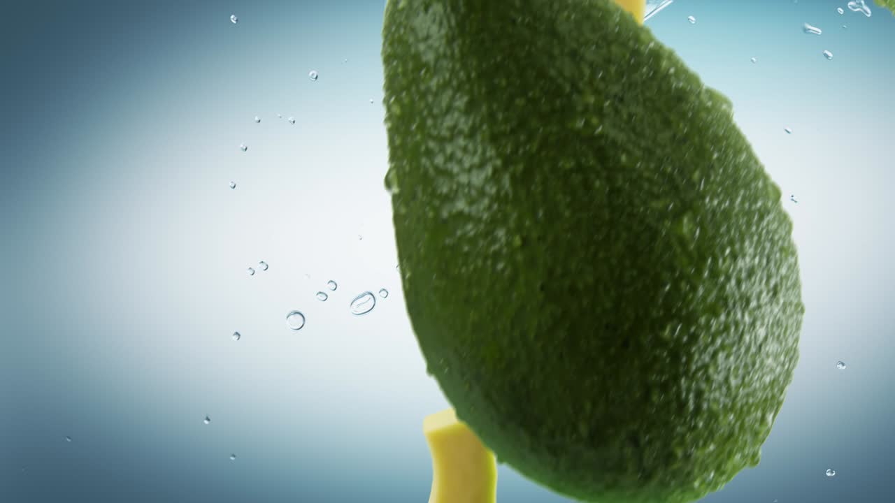 파편과 스플래시가 시안 바탕에 떨어지는 아보카도