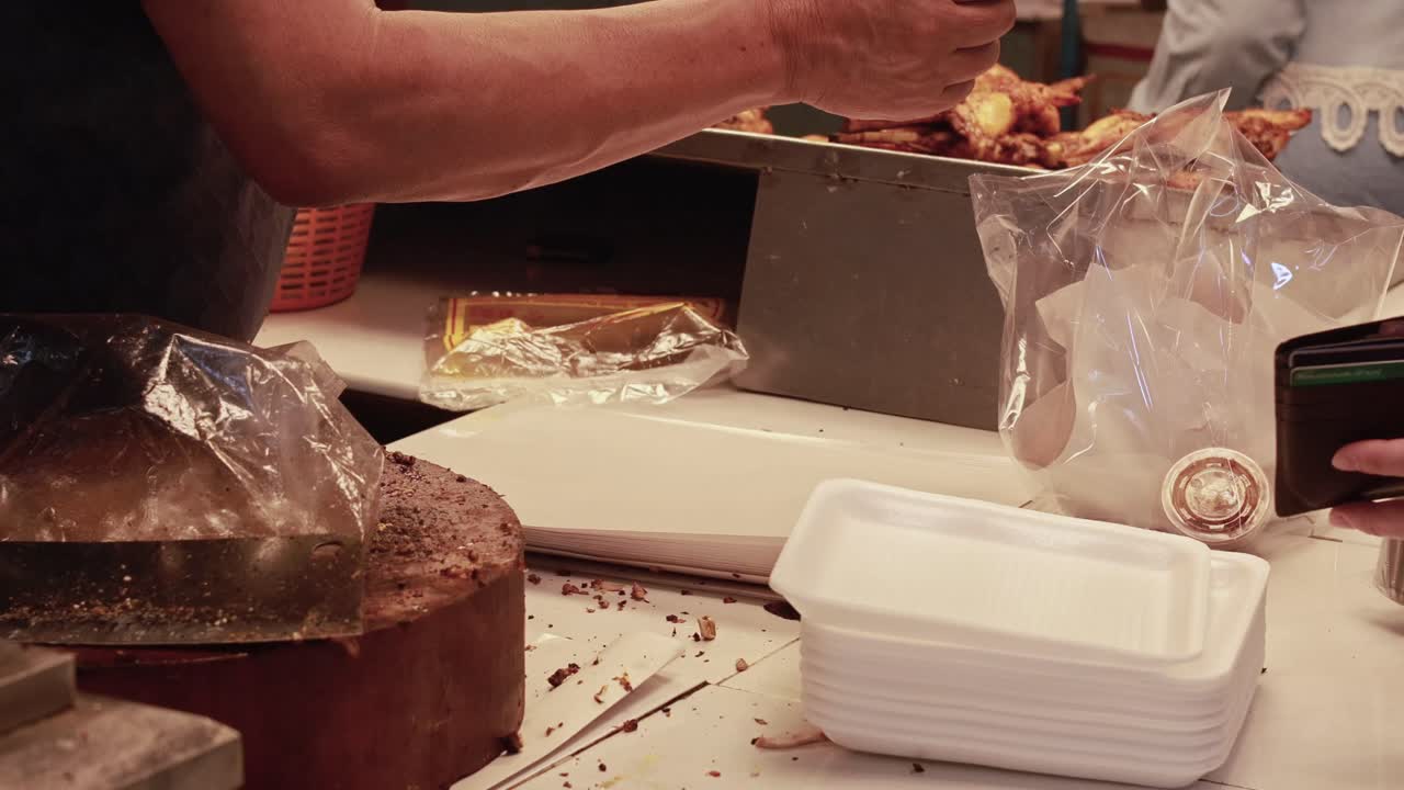 vendedor que sirve comida y recibe el pago