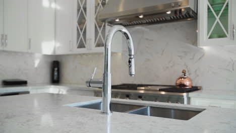 stainless steel faucet in a modern marble kitchen