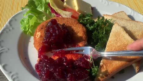 Eating-baked-camembert-with-fresh-jelly