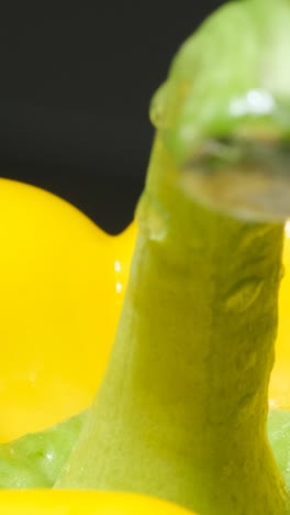 yellow pepper rotates on a black background. macro video