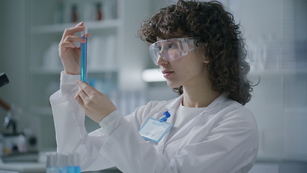 Portrait of Smiling Female Scientist Holding Test Tube in Laboratory