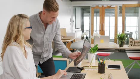 young man and woman working in a creative office