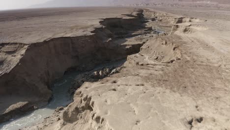 aerial view of a dry riverbed in a desert landscape