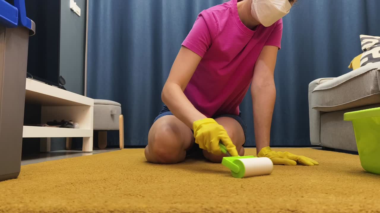 Woman Cleaning Carpet with Lint Roller