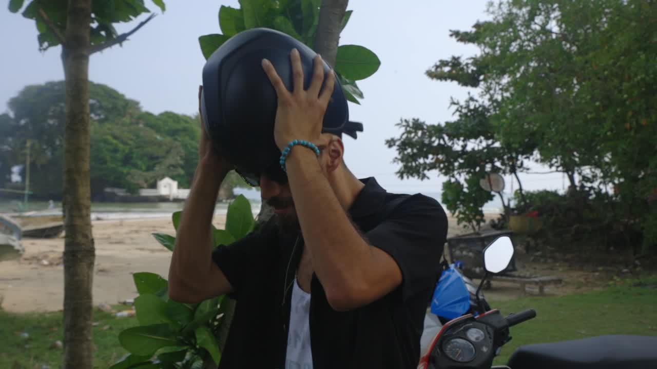 그의 헬멧을 벗고 스리랑카 웰리가마의 경치를 감상하는 관광객