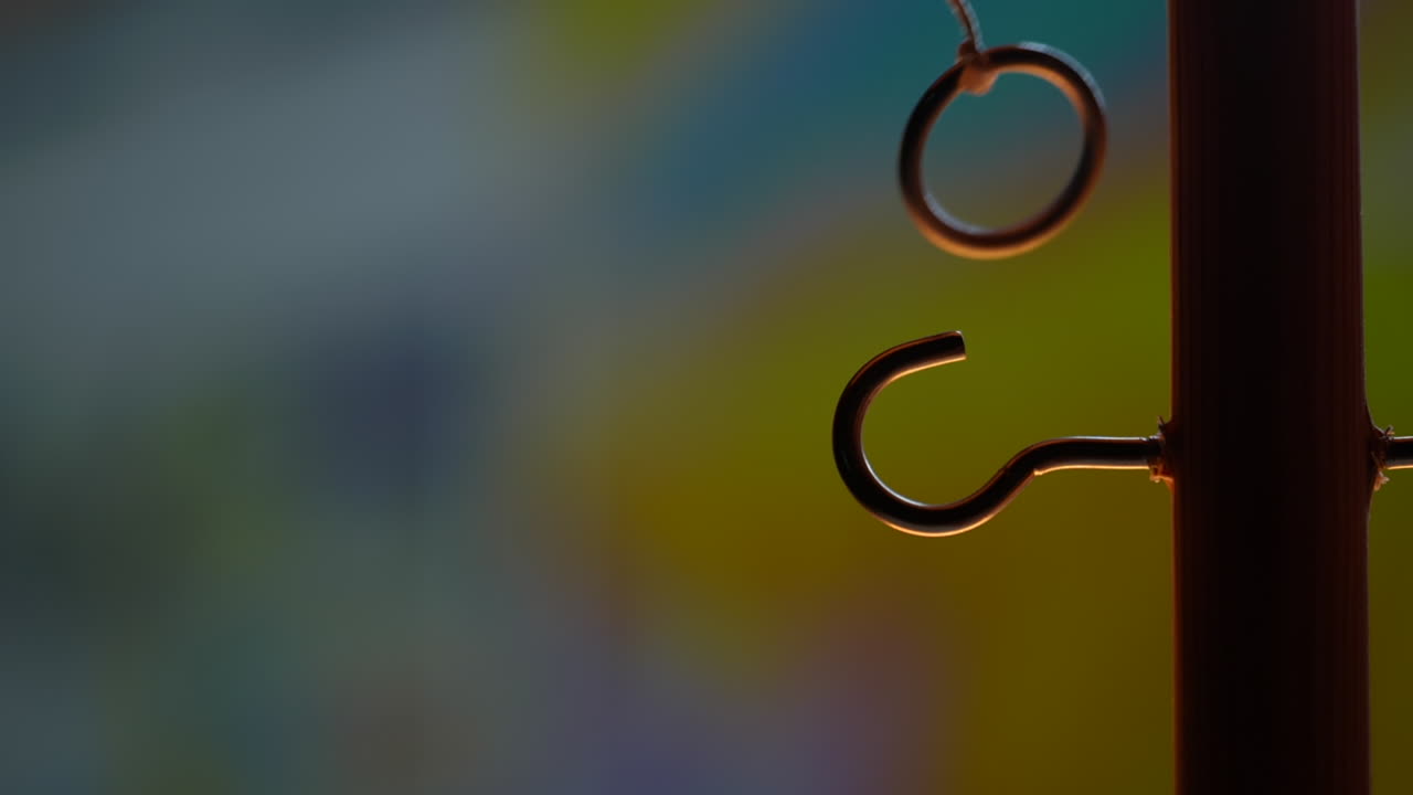 Vintage Ring a Bull retro classic pub game swinging suspended ring onto a hook, slow motion, close up