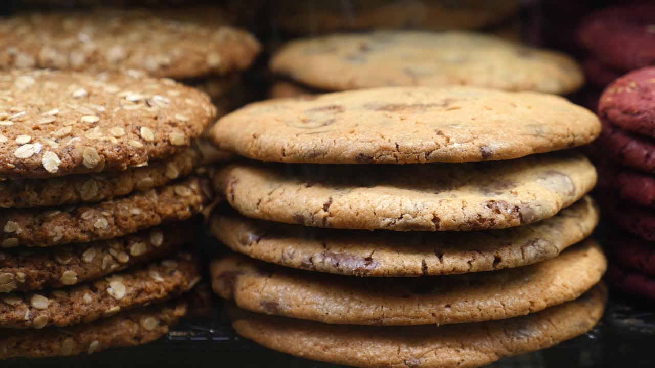 Close-up of a stack of chocolate chip cookies, oatmeal cookies and red velvet cookies