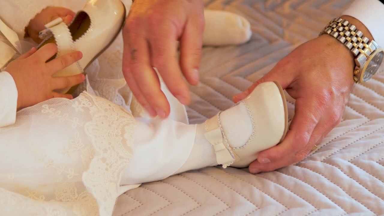 Putting on Baby Girl Shoes – Tender Moment in Close-Up