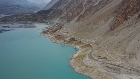 Aerial-View-Of-Attabad-Lake-Next-To-Karakoram-Highway,-Hunza-Valley-In-Gilgit−Baltistan,-Pakistan---drone-shot