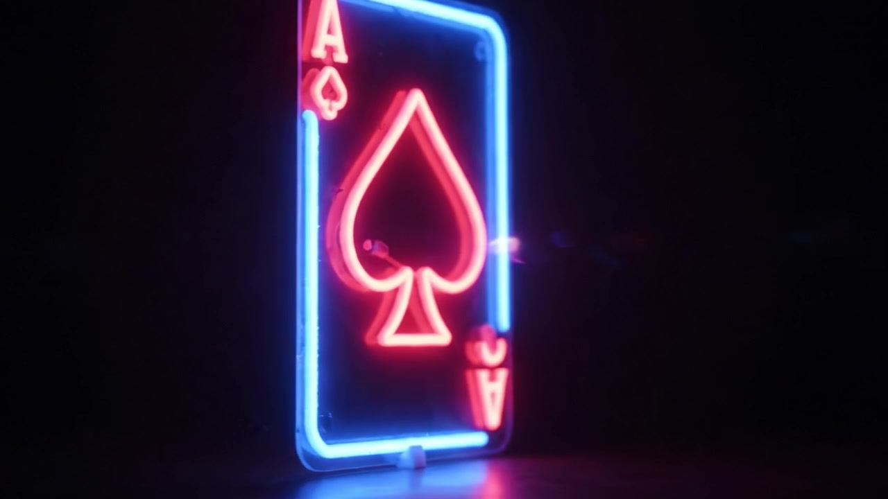 A captivating neon representation of the Ace of Spades playing card, glowing in blue and red hues, highlighting the iconic spade symbol against a dark background.