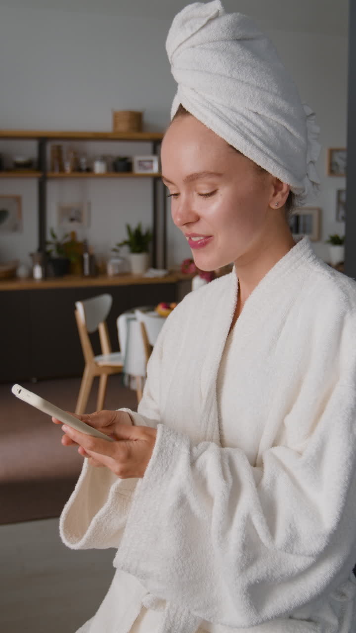 Woman in Bathrobe with Smartphone