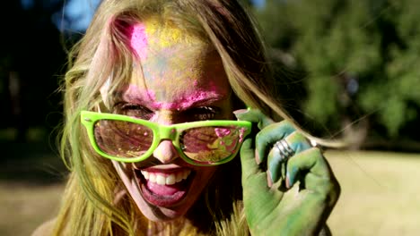 close up face shot of girl covered in holi powder