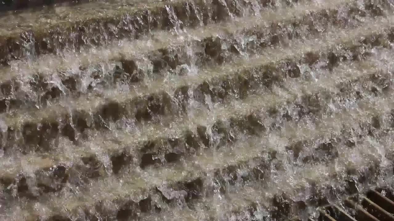 Water tumbles over a steps of a fountain