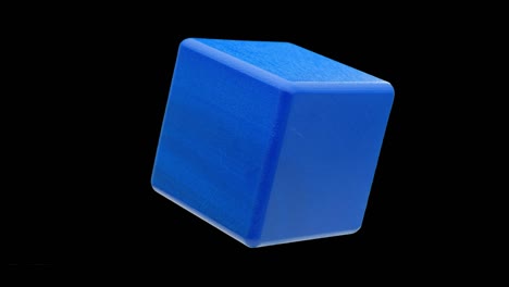 wooden blue cube isolated. looped rotation.