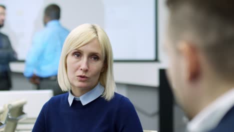 mid-aged lady speaking with colleague