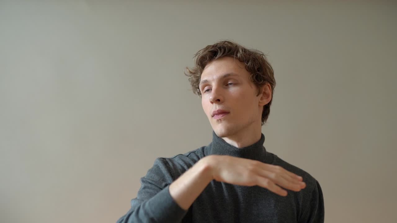 The guy with the glasses leads his hand on the imaginary screen