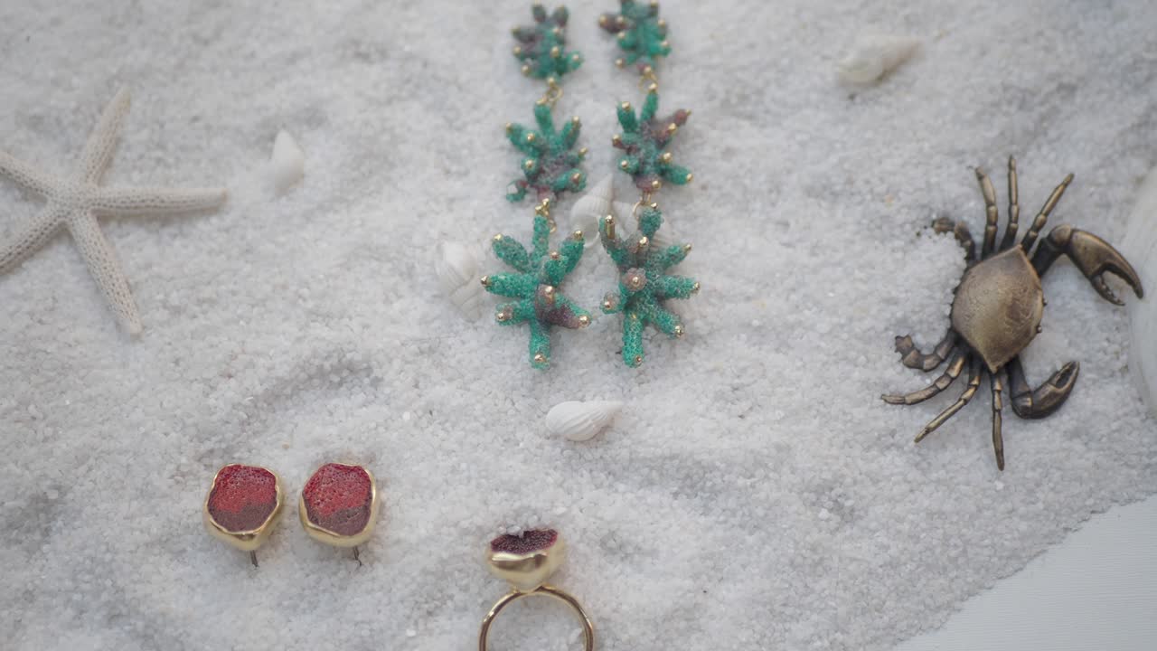 Sea-themed jewelry on sand