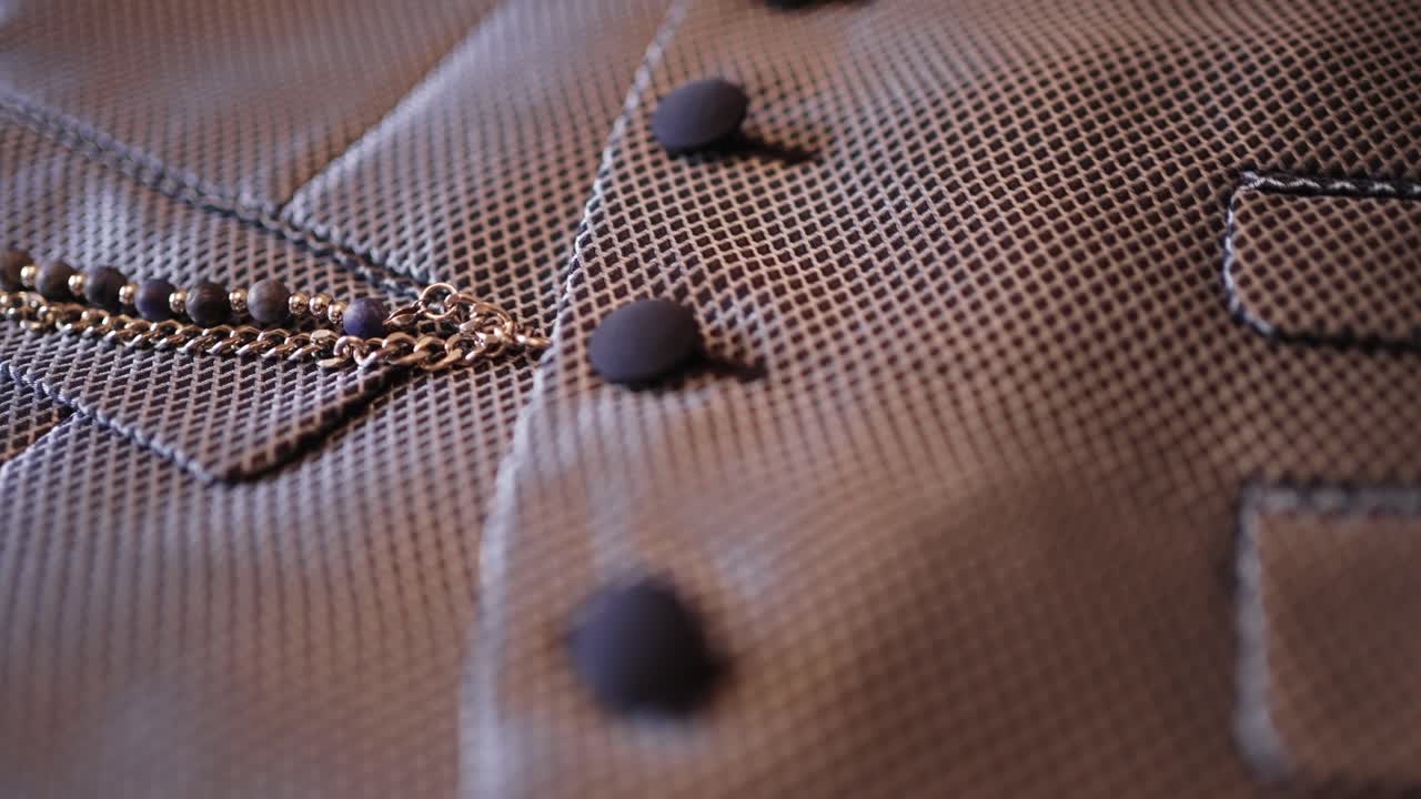 elegant textured jacket with chain and soft round buttons