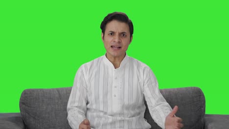 angry indian man shouting on someone green screen