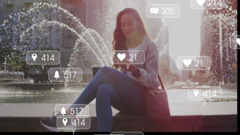 animation of social media icons and business data over biracial woman using smartphone
