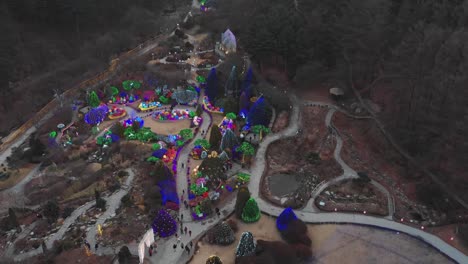 drone panning up shot of the garden of morning calm korean winter light festival