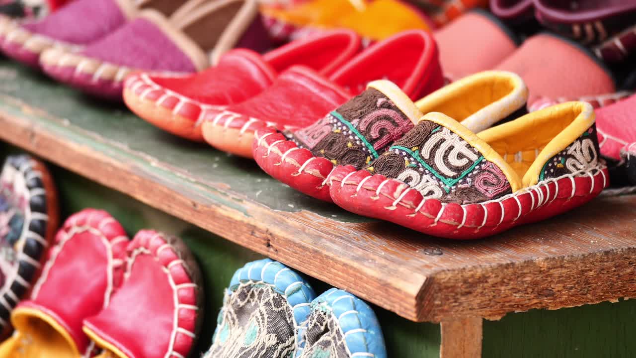Colorful Handmade Children's Slippers on a Wooden Shelf