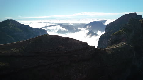 tiny-person,-hiking-in-huge-mountain-landscape-overview,-high-altitude-aerial-of-hike-trail-path-in-Madeira