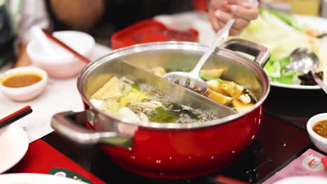 preparing hotpot meal with fresh ingredients